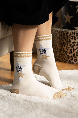 Image of the model wearing socks from the Set Of 4 Leopard & Animal Print Socks