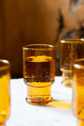 Image of the Set Of 4 Stackable Amber Glass Tumblers on a table