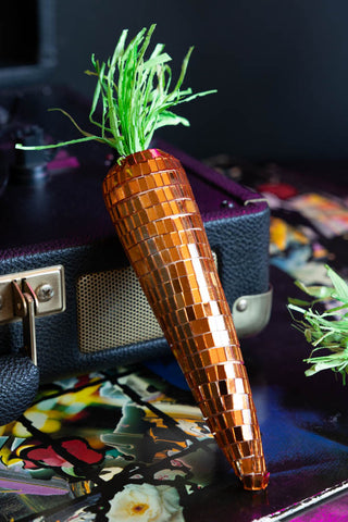 One of the Set Of 6 Disco Carrot Easter Decorations style leaning against a record player.