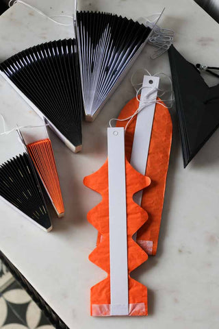 Image of the Set Of 7 Black & Orange Paper Decorations folded up