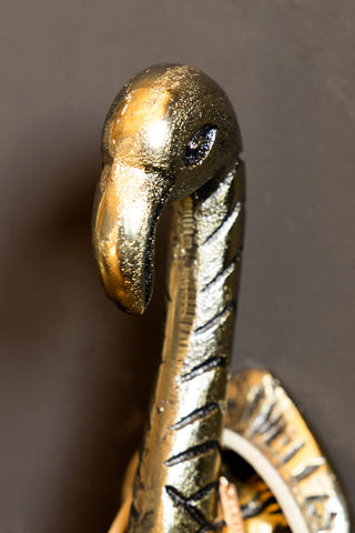A close up detail of the head of one the Antique Gold Flamingo Head Coat Hooks.