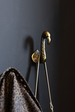 The Set of 2 Antique Gold Flamingo Head Coat Hooks shown holding a bag and jacket. 