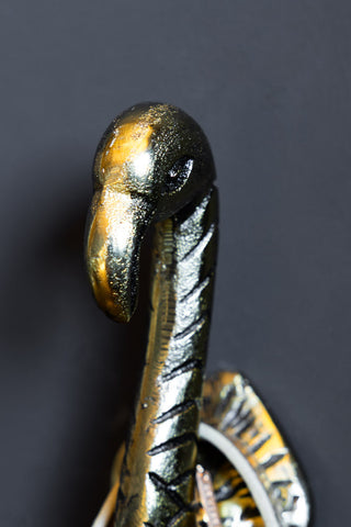 A close up detail of the head of one the Antique Gold Flamingo Head Coat Hooks.