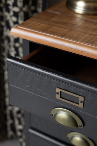 Close-up of the open drawer of a bedside table.