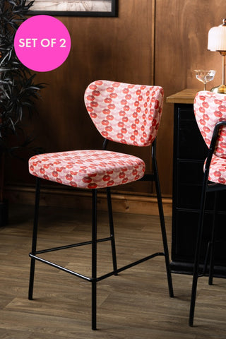 The Set of 2 Bar Stools in Lips Print Velvet styled by a wooden sideboard.