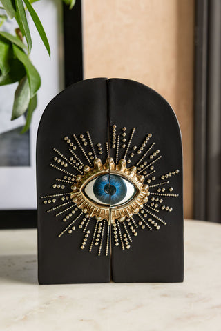 The Set of 2 Black Mystic Eye Bookends shown styled without any books. 