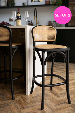 Lifestyle image of the Chez Pitou Black Wood & Woven Cane Bar Stool in a kitchen
