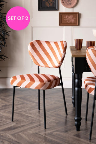 The Set of 2 Dining Chairs in Pink & Amber Stripe styled with a dining table.