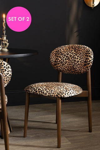 The Set of 2 Leopard Wooden Dining Chairs styled with a round table.