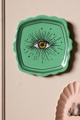 Close-up of the green eye plate from the Set of 3 Colourful Face Wall Plates.