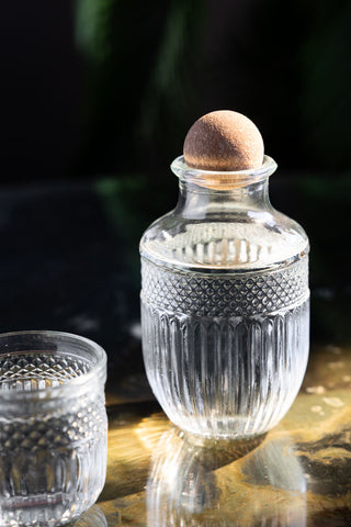 Close-up of one of the Set of 3 Vintage-Style Glass Carafes & Stacking Tumblers.