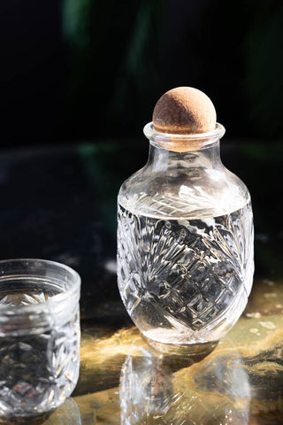 Close-up of one of the Set of 3 Vintage-Style Glass Carafes & Stacking Tumblers with a diamond design.
