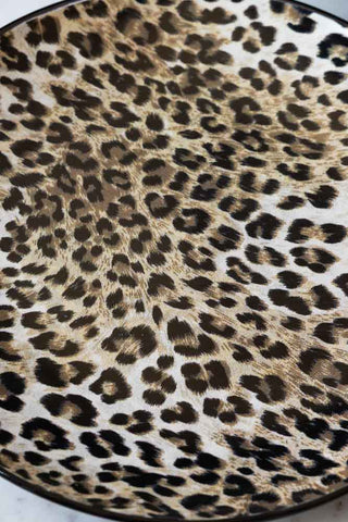 A detail shot showing the print of the  Set of 4 Leopard Print Dinner Plates.