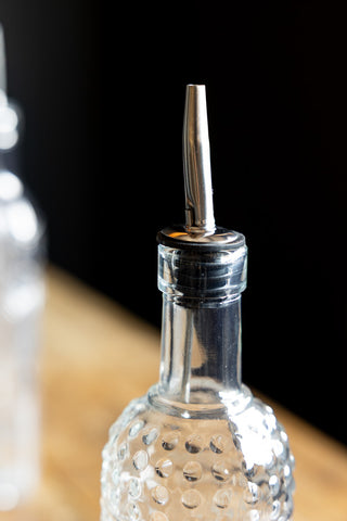 Close-up of the nozzle of one of the Set of 4 Vintage-Style Oil Dispenser Glass Bottles.