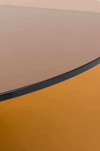 Close-up of the edge of the Seventies Amber Glass Oval Coffee Table.