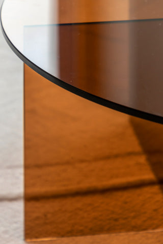 Close-up of the edge of the top of the Seventies Amber Glass Oval Coffee Table.