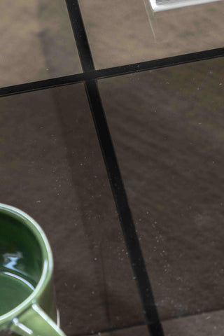 Close-up of the top of the Seventies Smoked Glass Oval Coffee Table with a mug on.