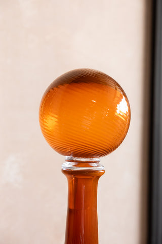 The glass ball stopper on the Seventies Swirl Orange Glass Decanter. 