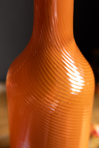The unique glass pattern of the Seventies Swirl Orange Glass Decanter.