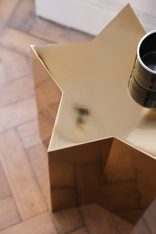 Aerial view of the Shiny Gold Star Side Table styled with a mug. 