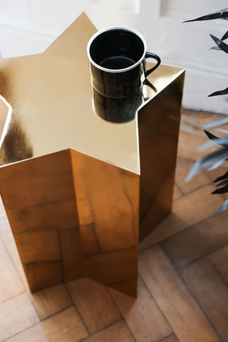 Aerial view of the Shiny Gold Star Side Table styled with a mug.