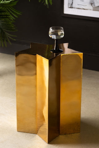 Shiny Gold Star Side Table styled with a glass