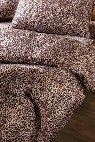 The Signature Leopard Print Cotton Sateen Bedding Set displayed on a bed.