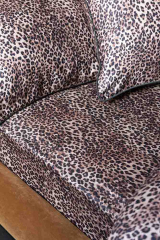 Close-up of the Signature Leopard Print Cotton Sateen Fitted Sheet on a bed with some matching pillowcases.