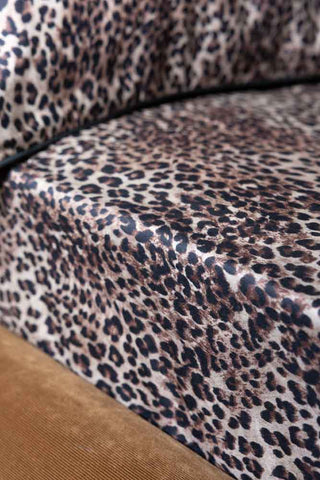 Close-up of the Signature Leopard Print Cotton Sateen Fitted Sheet on a bed.