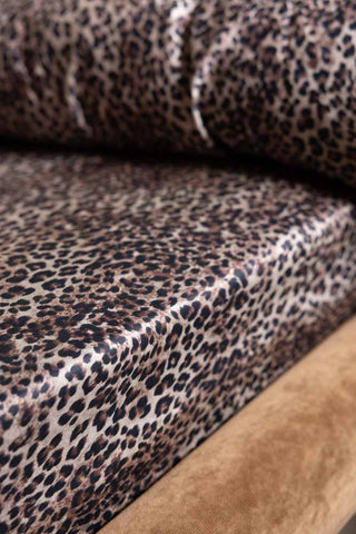 Close-up of the Signature Leopard Print Cotton Sateen Fitted Sheet on a neutral coloured bed.