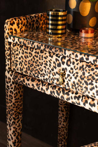 A close up detail showing the glass top and drawer detailing (including the gold hand handle) on the Signature Leopard Print Velvet Dressing Table & Stool.