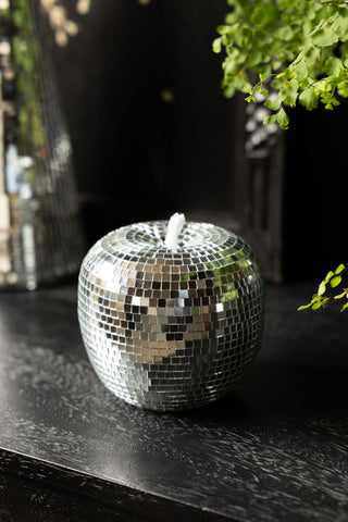 The Silver Disco Ball Apple Decoration, shown on a black sideboard. 