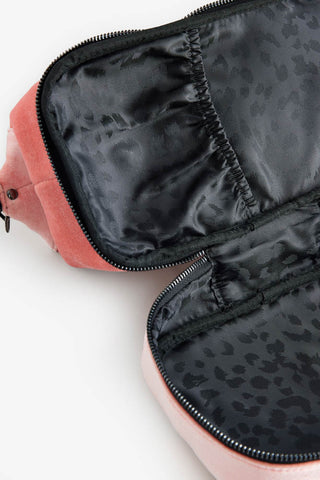 The inside the Sisterhood Blush Pink Velvet Washbag, with a black leopard lining and pocket compartment. 