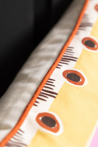 Close-up of the piping on the edge of the Sisterhood Charity Rectangular Cushion.