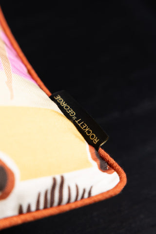 Close-up of the Rockett St George tag on the Sisterhood Charity Rectangular Cushion.