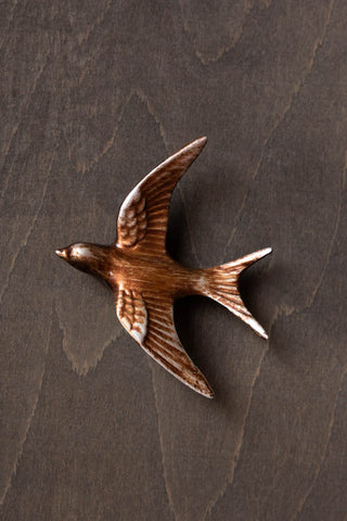 Close-up image of the Small Antiqued Copper Swallow Wall Decoration