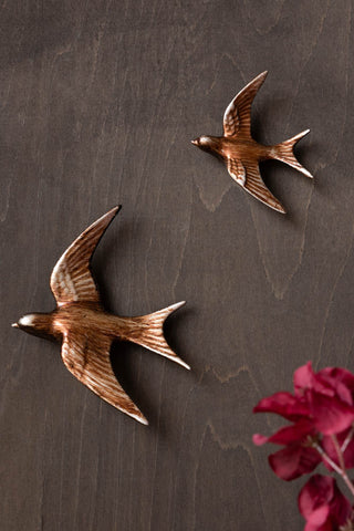 Image of the Small Antiqued Copper Swallow Wall Decoration on a wall
