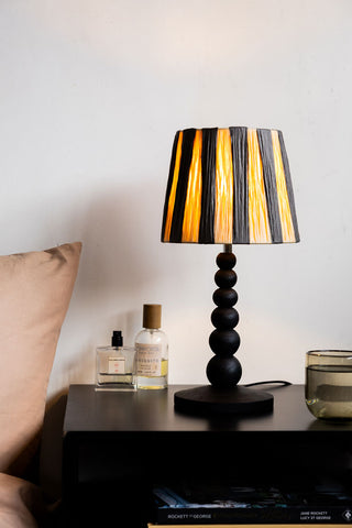 Lifestyle image of the Small Black Bobbin Bedside Table Lamp