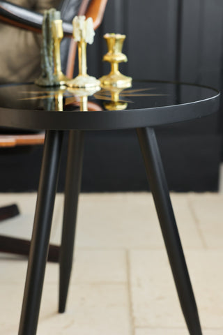 Detail image of the side of the Small Black Star Side Table. 