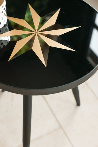 Detail image of the top of the Small Black Star Side Table. 