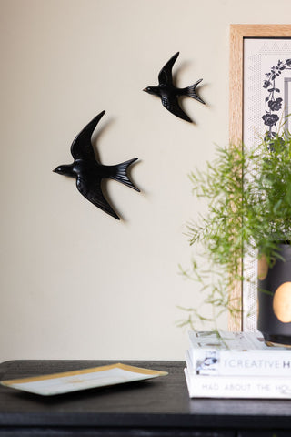 Image of the Large and Small Black Swallow Wall Decorations on a wall