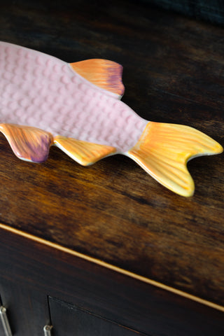 Image of the bright orange/yellow fish tail of the Snapper Fish Serving Plate