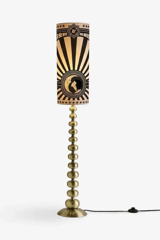 The Solar Goddess Bobbin Floor Lamp as a cutout image switched on