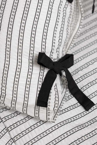 Starstruck Stripe Seersucker Bedding Set, showing the detail of the black pillow ties