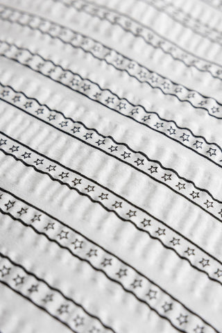detail shot of the star stripe pattern of the Starstruck Stripe Seersucker Bedding Set.