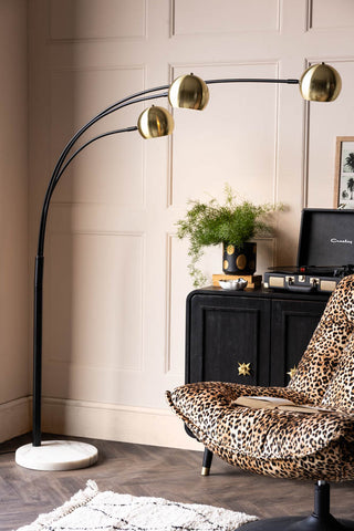 Lifestyle image of the Statement Black & Gold Retro Arch Floor Lamp