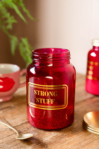 Lifestyle image of the Strong Stuff Hot Pink Glass Storage Jar