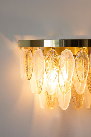 Close-up of the illuminated Stunning Art Deco Glass Feather Wall Light.