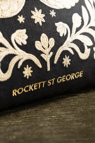 Close-up of the Rockett St George logo on the Swan Tapestry Embroidered Cushion.