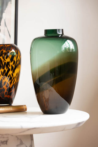 Lifestyle image of the Tall Dark Green & Brown Glass Vase